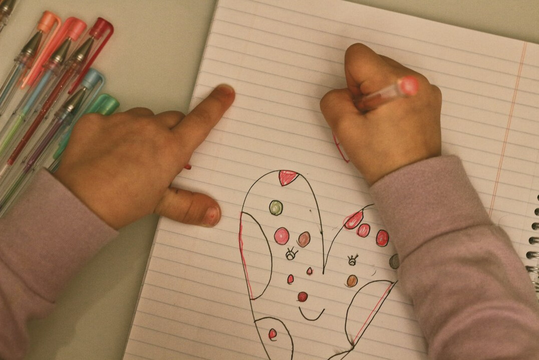Close-up of hands writing in a notebook